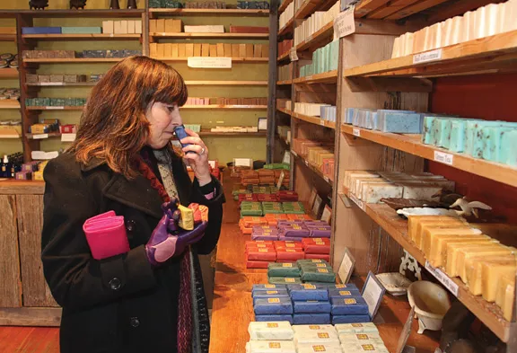 Beth Kalet of Warwick samples some of the handmade soaps available at Rosner Soaps in Sugar Loaf. - ADAM FERNANDEZ