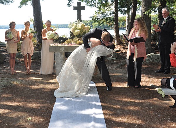 Celebrant Amy Benedict officiates a wedding on Bear Island in Lake Winnipesaukee in New Hampshire. - KEITH SLINEY