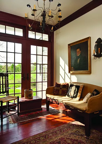 In the sun-drenched mud room, high-country antiques are paired with a circa 1820 portrait. - DEBORAH DEGRAFFENREID