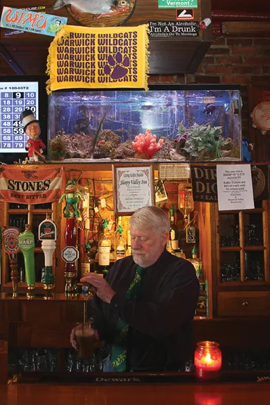 John Christison pours a pint of Guiness at his pub Yesterdays in Warwick. - ADAM FERNANDEZ