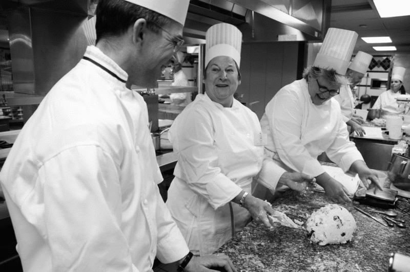 Lecturing Instructor Stephen Eglinski (left) consults over an orange and cranberry scone dough prepared by Culinary Institute of America Boot Camp students Linda Jochem and Pam Burt. - TONY FIORINI