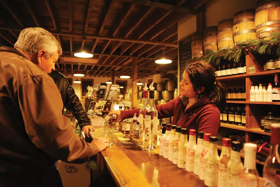 Luz Reid serves samples of locally microdistilled liquor at the Tuthilltown Spirits tasting room in Gardiner. - KELLY MERCHANT