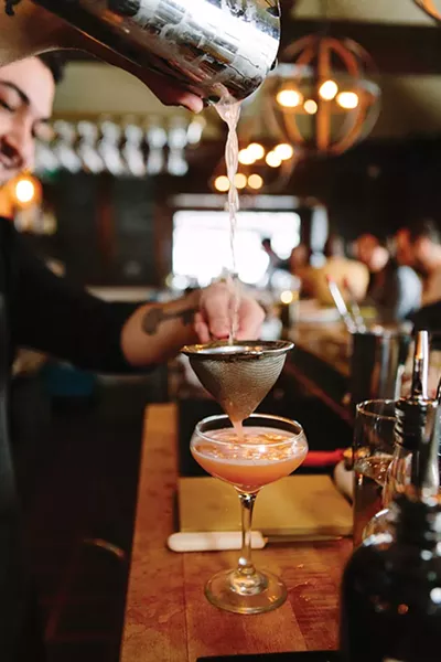 Mixing the signature Pink Panty Dropper cocktail - THOMAS SMITH
