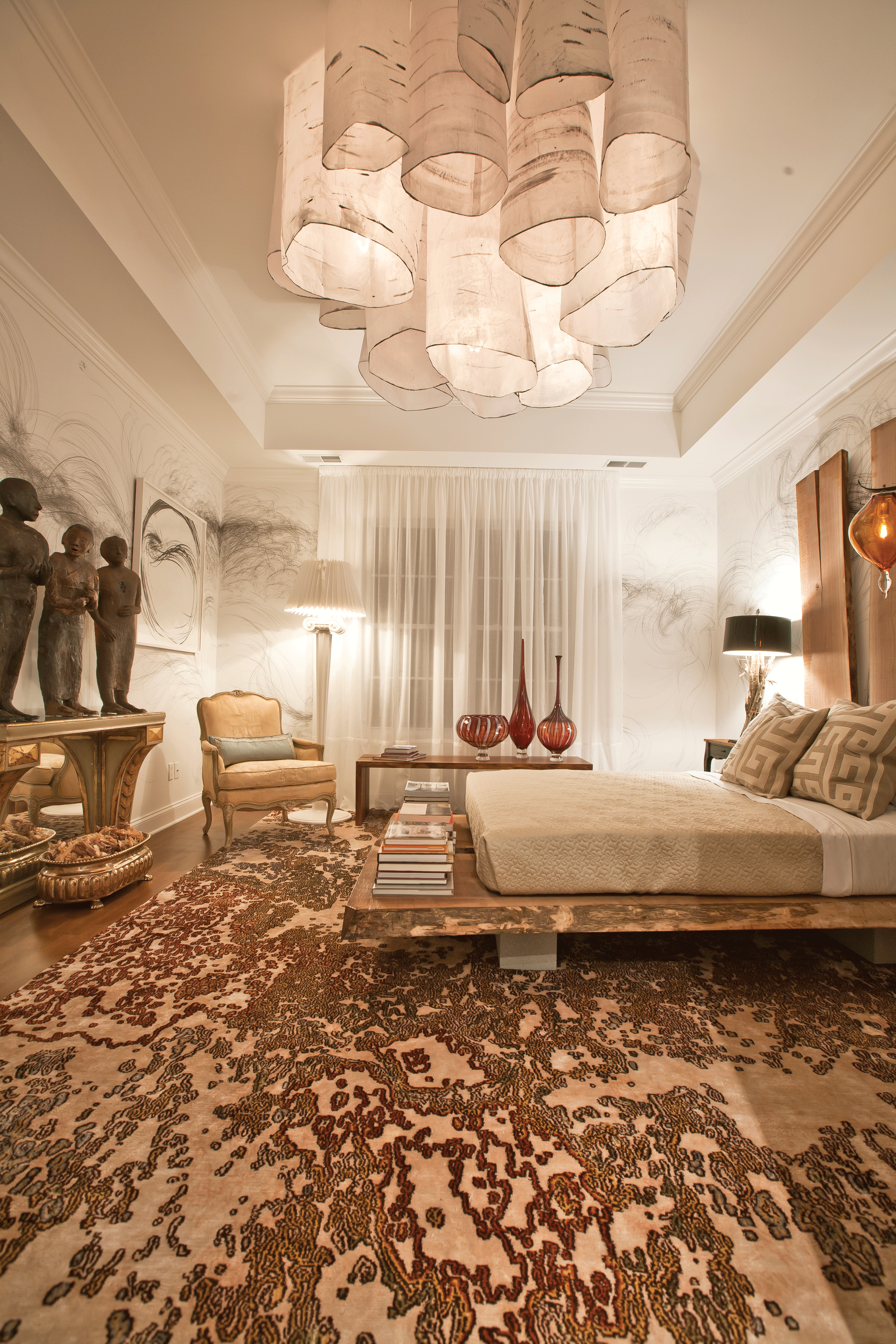 Photo of interior designer Charles Burleigh’s master bedroom at the ArtFull Living Designer Show House. Burleigh collaborated with artists Jaanika Peerna (drawings on the wall), Ada Pilar Cruz (ceramic sculptures), Kaija Koorpijaakko (paper ceiling installation), and Jessica Wickham (walnut bed).