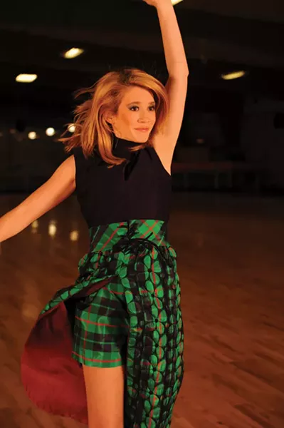 Quilted Queen of the Rink: Isabelle Leggat wearing a late 1960s / early 1970s blue and green quilted open skirt with matching shorts in taffeta and matching belt. Sleeveless turtleneck bodice with keyhole front. Makeup by Saadah Garbey. From Judy Go Vintage. - KELLY MERCHANT