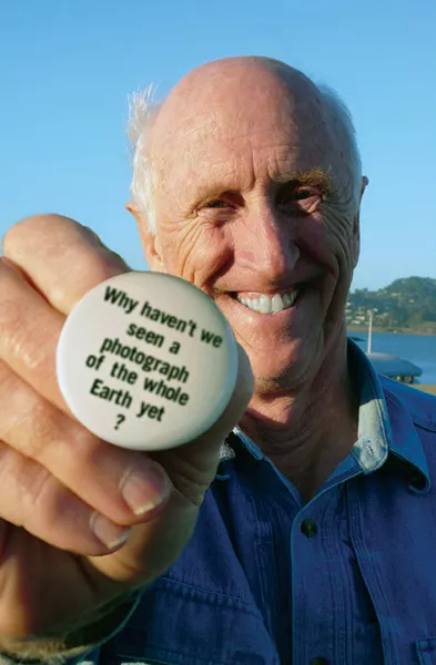 Stewart Brand with the button that launched a movement in Earth Days.