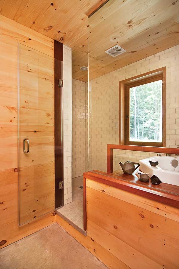 The bathroom features a Japanese-style deep soaking tub. Ceramics by Peter Barrett.