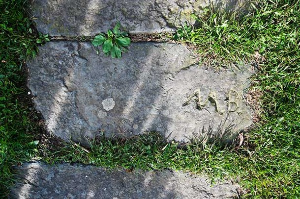 The initials of Matthew Bambrick, who resided in the home in the early 1900s.