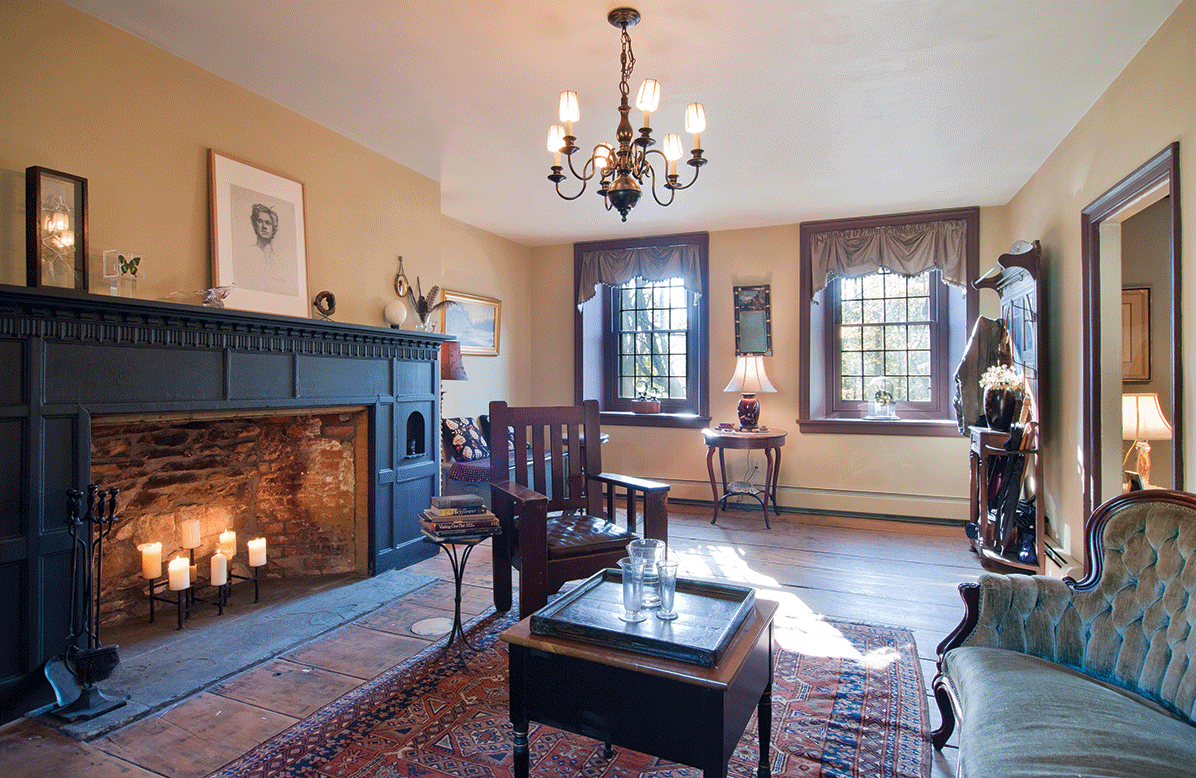 The sitting room, featuring an early 20th-century fireplace mantel faced with ebonized black paint. - DEBORAH DEGRAFFENREID