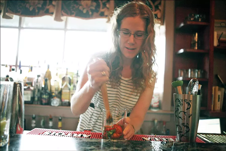Theresa Fall of 36 Main muddling strawberries for her strawberry mint margarita. - AMBER C. MCPHAIL