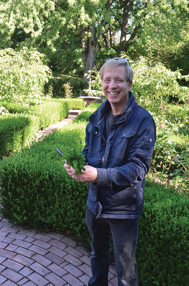 Food and garden blogger Kevin Lee Jacobs in his boxwood garden in Kinderhook. - LARRY DECKER