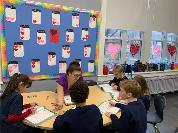 Second-grade students with teacher Dianna DiIulio in a blended learning lesson.