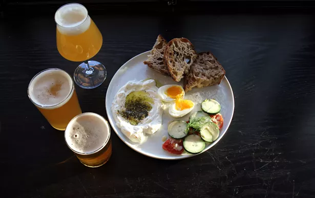 A selection of beers with the Atlantic Avenue breakfast: soft-boiled egg, labneh, roasted tomatoes, cucumbers, and levain toast. - ABBY FOSTER