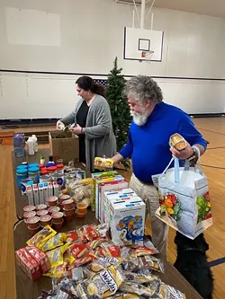 Volunteers unbox groceries at San Miguel Academy's COVID-19 pantry - COURTESY OF SAN MIGUEL ACADEMY