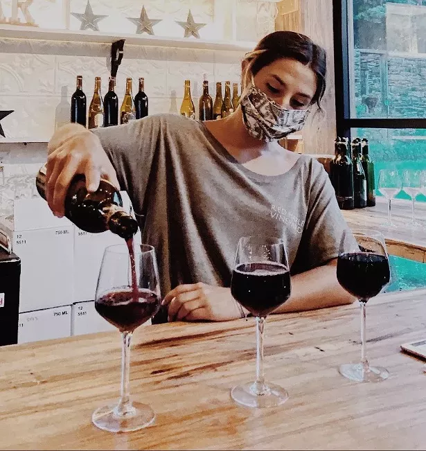 Winemaker Madi Marshall pouring wine