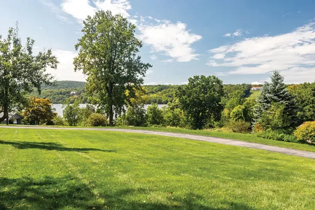 Set on a grassy hill in Hyde Park, Smyle and Schultz's Mid-Century Modern home enjoys sweeping views of the Hudson River. - PHOTO BY WINONA BARTON-BALLENTINE