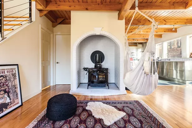 The home’s arched brick alcove and woodstove are the final remnants of the home’s - original southwestern-inspired interior. Throughout the home, a mix of Oriental area rugs line the wood plank floors. Some were bought while traveling in Istanbul and some were bought at Anatolia in Woodstock. - PHOTOS BY WINONA BARTON-BALLENTINE