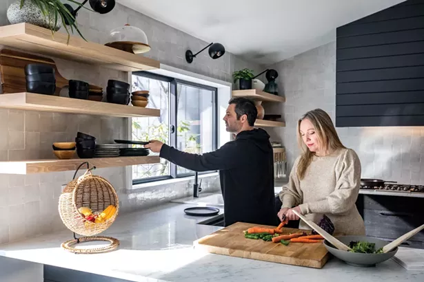 Oldenburger loves to cook. “I love all types of cuisine— Indian, Thai, French—and I try to cook everything,” she says. “In this regard, the pandemic wasn’t a huge change - for me because I’m pretty much always cooking at home.” Originally, she considered opening the space between the breakfast nook and kitchen, and then installing an island. “But the fact is, I like it when people stay out of my way in the kitchen,” she says. “With the U-shaped counter, we can still hang out while I work.” The kitchen features white Carrara marble counters, a custom range hood by Tom Mayone, and walls of handmade Moroccan tiles. - PHOTO BY WINONA BARTON BALLENTINE