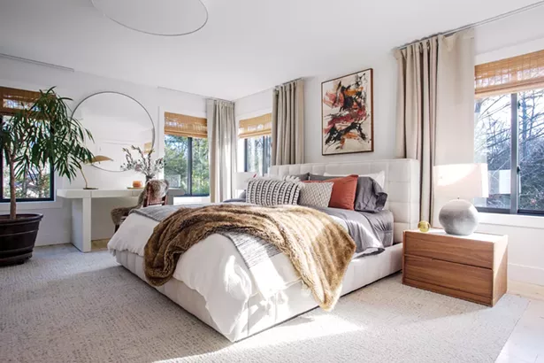 Like the rest of the house, the master bedroom showcases Oldenburger’s design influences. “I have always been attracted to Midcentury Modern design and Modern architecture,” she says. “I am really influenced by contemporary design movements - in California, Australia, and Mexico that focus on minimalist design and incorporate their respective environments.” The 1968 painting above the bed was bought from an antique dealer. “We are on the hunt for the artist because the signature is nothing we - recognize. It’s one of our great mysteries.” - PHOTO BY WINONA BARTON BALLENTINE