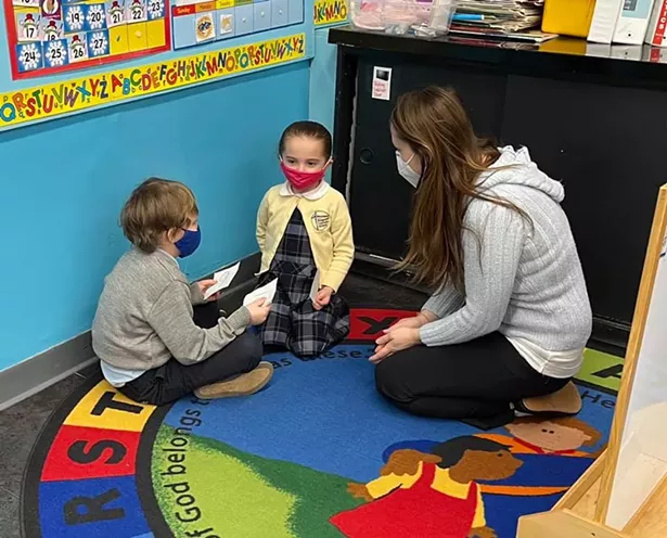 A Kindergarten teacher and students on rug during a math lesson - IMAGES COURTESY OF KINGSTON CATHOLIC SCHOOL