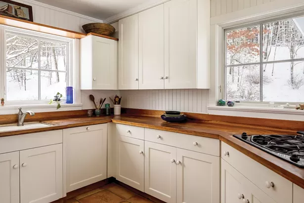 The cherry wood counters in Ylvisaker’s kitchen were - inspired by her grandmother’s farmhouse kitchen. The - windows look out past her yard to the woods and hillside - behind the house. - WINONA BARTON BALLENTINE