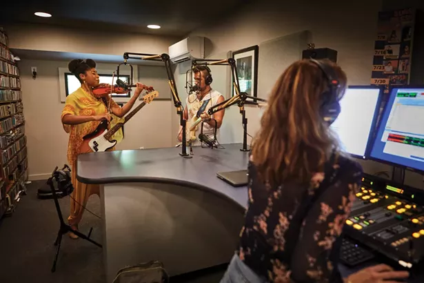 Inside Radio Woodstock’s new home, a renovated church, DJ Aja broadcasts live with Aziza & the Cure, a wife-and-husband duo, Joelle and River Rouen. - DAVID MCINTYRE