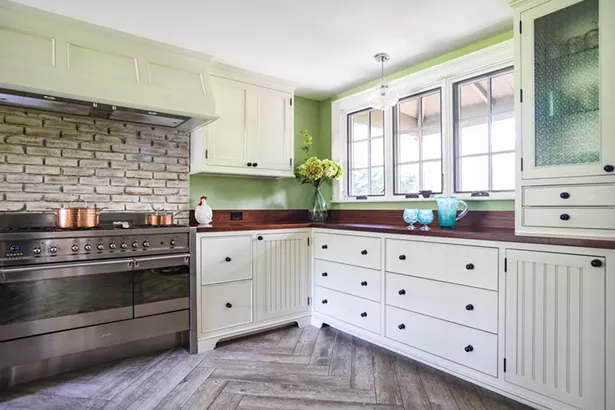 The house’s original woodstove (it’s now in his carpentry shop) was replaced with a stainless steel six-burner stove. The kitchen is finished in African ribbon-striped sapele wood on the counters and pantry cabinets. Jackson added the south-facing window over the counter. “It really brings the outside inside,” he says. - WINONA BARTON-BALLENTINE