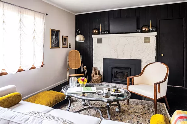 Salvemini added a wood insert into the home’s fireplace. Her living room design was inspired by the Coleman Hawkins’ song “Rosita.” “When I first saw the room, it reminded me of a swanky jazz song, with a bit of brass,” she says. “That musical influence gave me the design directive for the living room. Now whenever I walk in I can hear the slide part of the song.” The abstract print is by James Gilroy. - WINONA BARTON-BALLENTINE