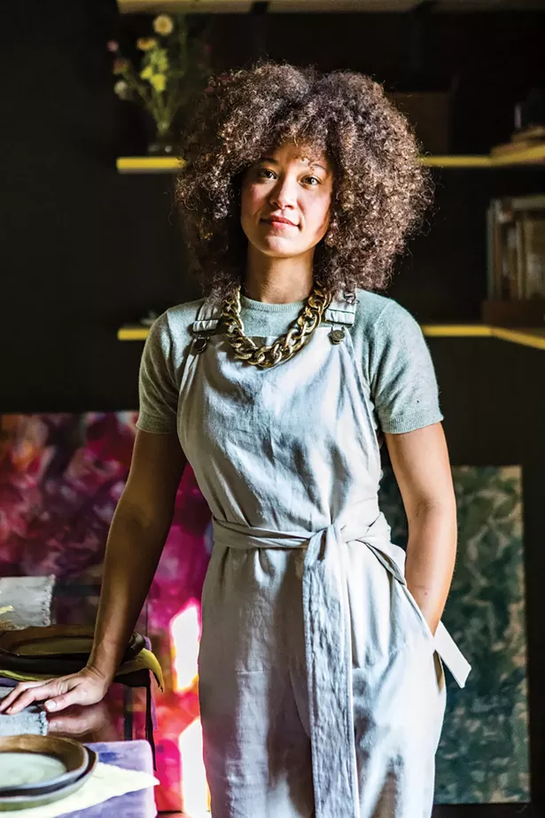 Salvemini wears a Yardie jumper from Nyamka Ayinde’s Catskills uniform apparel collection. “I think the drive to create is a biological urge in a way,” she says. “For many women, self-care is at the absolute bottom of the list. Part of the showroom collective’s mission is showing up for each other.” Behind her, a large abstract painting by Caroline Burdette. - WINONA BARTON-BALLENTINE