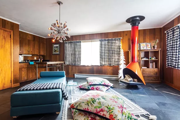 Salvemini closed walls in her living and dining room to create a separate short-term rental unit. “The windows are surrounded by old maple trees,” she says. “And it can feel like you’re sleeping in a tree house, waking up surrounded by shimmering leaves.” - WINONA BARTON-BALLENTINE