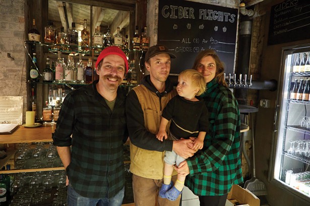 Left Bank Cider owners David Snyder, Tim Graham, and Anna Rosencranz with their son. - PHOTO BY DAVID MCINTYRE