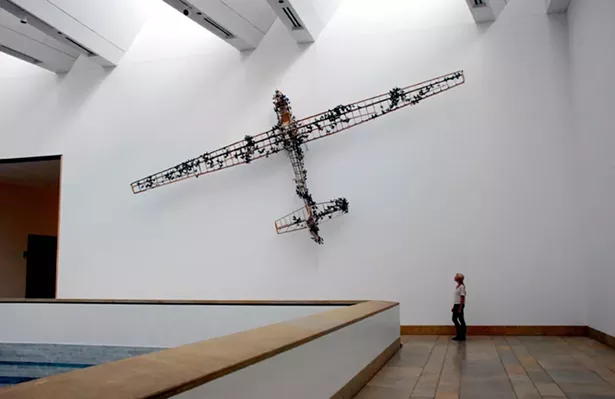 Paul Villinski, Passage, 2013, Installation view, Blanton Museum of Art, University of Texas, Austin - Salvaged wood, aluminum (found cans), wire, soot, steel, aircraft instruments; 3'-2” x 33' x 15'-4”