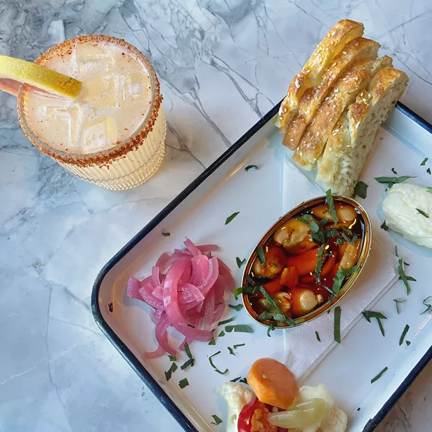 Conservas served with pickled onions, giardiniera, and housemade foccacia