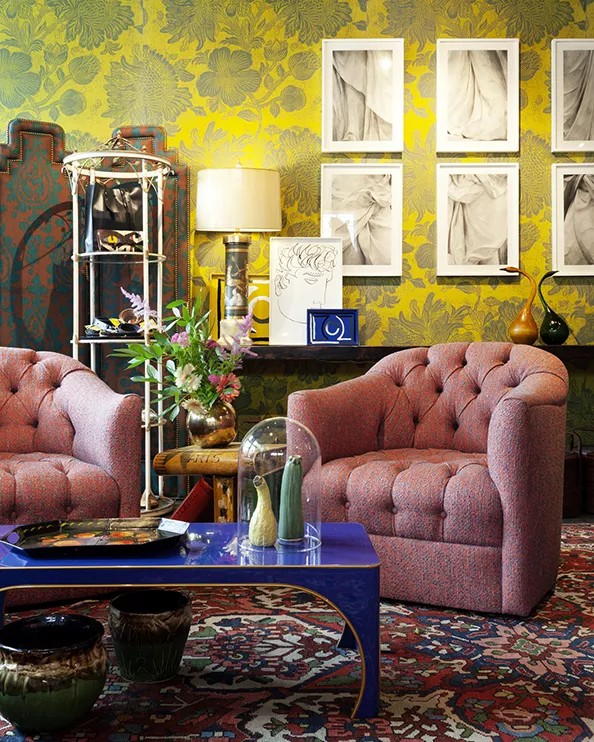"The store is meant to feel like a room that is expertly appointed with layers of color and texture to inspire both the trained design eye and the casual observer" says partner Rachael Stollar. - This set of swivel chairs is upholstered in a Métaphors fabric called Zanzibar Cayenne. The tufted detailing is reminiscent of a Midcentury Modern design. "We wanted the chair to be quite tailored but also incredibly comfortable which is sometimes difficult to achieve in a larger scale chair," says partner Ward Welch. - The Federalist House Screen in the background has a straight top with Ted Tyler Pineapple fabric.