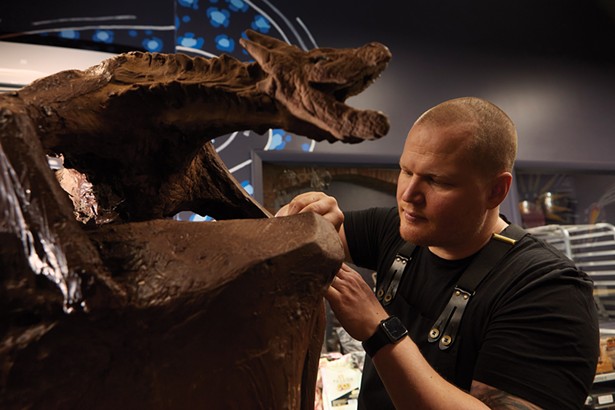 Swedish-born chocolatier Hakan Martensson working on a chocolate dragon sculpture in his Beacon store. - DAVID MCINTYRE