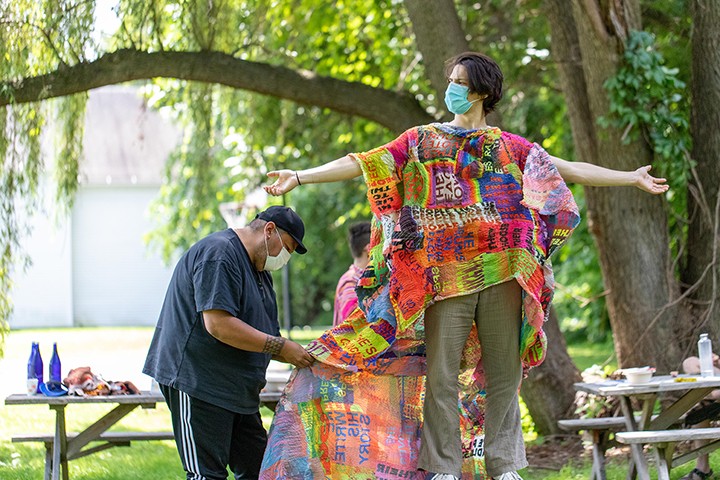 Jeffrey Gibson dressing a participant in one of his garments. Those individuals that I put in the garments, their personal narratives become intertwined by my personal narrative and it leaves an archive that is powerful, that is present tense, that will describe me, of course, but also what was happening in the spaces that I moved through," says Gibson.