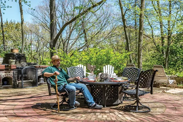 Greg Daigle in the backyard of his Cortlandt Manor home. He collected bricks to restore the patio’s interior circle. Bricks arranged in a basket weave pattern comprise the patio’s edges. The home’s brick-and-stone barbecue was built by the original owner at the end of World War II. Besides restoring properties in the area, Daigle spends time wandering in the woods or along the river, searching for natural treasures to incorporate into his own nature- inspired artwork. Daigle’s walking stick is one of his own creations made from a burled sycamore branch and finished with a metal end from an antique horse harness. - WINONA BARTON-BALLENTINE