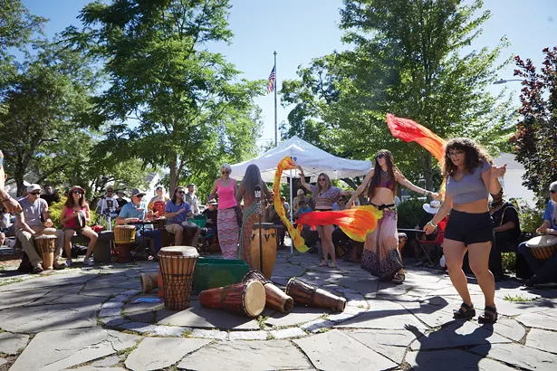 The Sunday drum circle on the Village Green draws locals and tourists alike to bang and boogie. - DAVID MCINTYRE