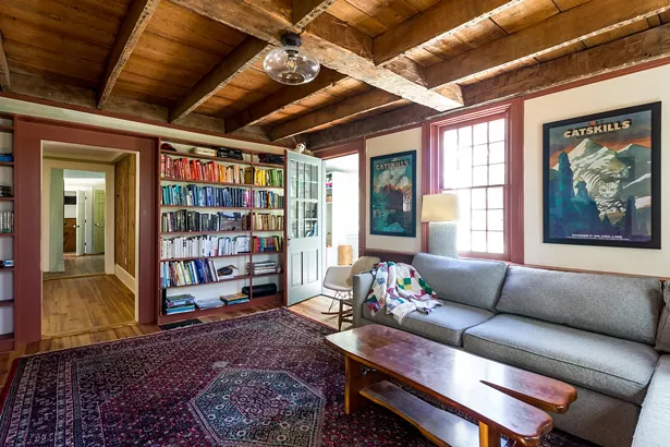 When the Reisfelds purchased the home, the first floor’s original dining room had been damaged by a flood. However, it turned out to be a blessing in disguise, uncovering the home’s original wood ceiling beams. “We knew we couldn’t cover them back up,” says Reisfeld. “They are all hand- cut and you can see the original Roman numerals on some.” The family now uses the space as a den. A collection of vintage Milton Glaser prints hangs along the wall. - WINONA BARTON-BALLENTINE