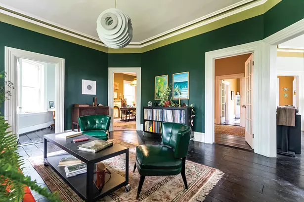 A first-floor sitting room features some of Bransford’s extensive art collection. Two works by the artist Max Razdow, a longtime friend and collaborator, hang above a collection of albums. After studying art in New York City, Bransford developed an interest in the artistic and alternative cultures of the Hudson Valley. “I’m especially drawn to the spiritualist movement and the Hudson River School of painting,” he says.
