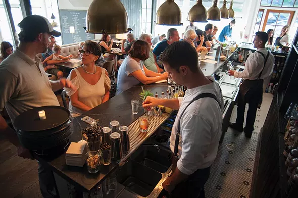 A.J. stirring a cocktail at Wm. Farmer and Sons in Hudson. - ROY GUMPEL