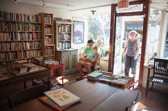 Owner Kristi Gibson, and Justin Brehm reading to Fiona at Magpie Bookstore in Catskill. - ROY GUMPEL