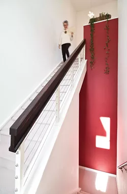 Meyer-Fitzsimmons in the stairwell leading to her home office. She began her research for her Master’s degree—which was to become her book Deep Living—in the `90s and found she really enjoyed the writing process. “It’s sort of like constructing a puzzle out of pieces of information.” - DEBORAH DEGRAFFENREID