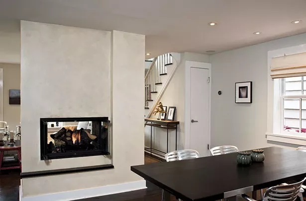 After removing the interior walls, Smith added a steel beam across the ceiling to support the chimney shaft. The metal and wood entrance table in the foyer is the creation of Smith’s wife, furniture designer Jules Anderson. Anderson specializes in utilizing natural materials in a contemporary fashion, and often recycles wood from local antique shops. Modernizing while still remaining true to a home’s (or a piece’s) historical roots is central to both their practices. - DEBORAH DEGRAFFENREID
