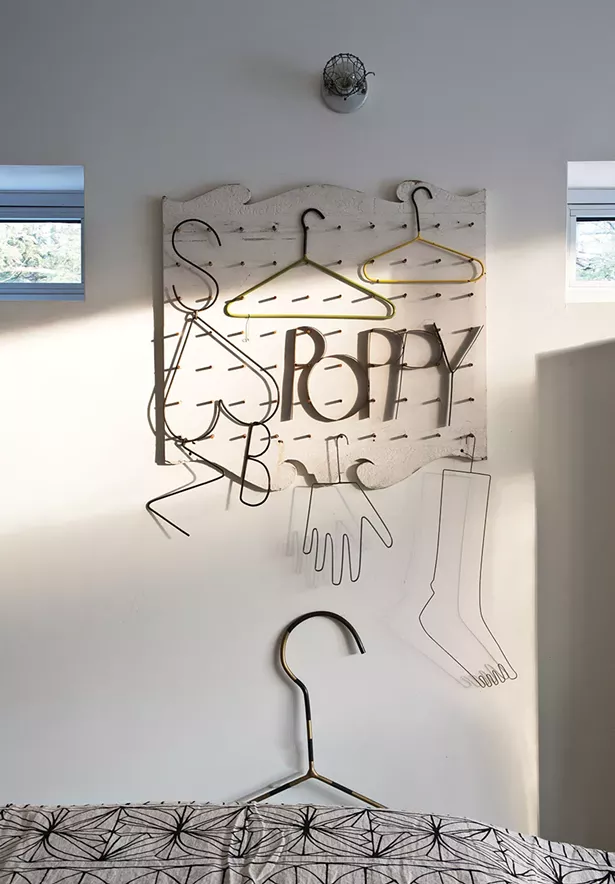 Another piece of Bissell’s metalwork hangs over her bed. Bissell loves the simplicity of welding metal. “I can heat it up and bend it,” she explains. “Just like with collecting junk furniture and castoffs: If it’s not easy and quick, I’m not interested.” - DEBORAH DEGRAFFENREID