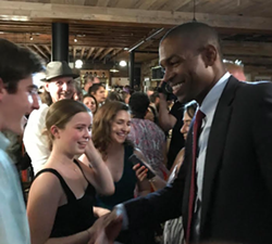 Delgado shakes hands with his interns. - ANDREW SOLENDER