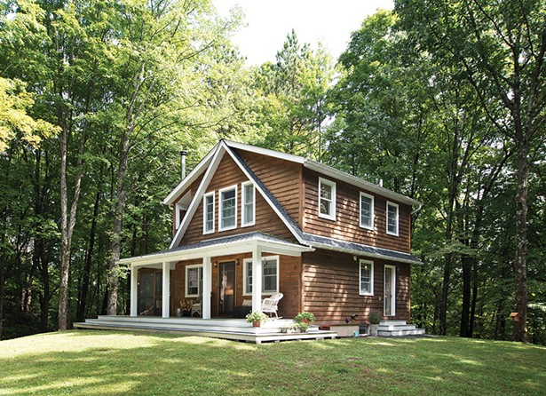 Aaron Bollman and Lisa Nicholas built their classically detailed cottage on a quiet country lane. - The design was inspired by the property’s previous cottage and built from wood salvaged from - its teardown. “It’s an evolution of what was here,” explains Bollman. - DEBORAH DEGRAFFENREID