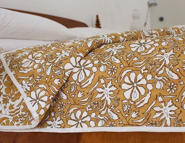Brush Textile quilts are hand-stitched with cotton thread in a 'long running stitch' technique that is left unknotted at the ends of each stitch.
