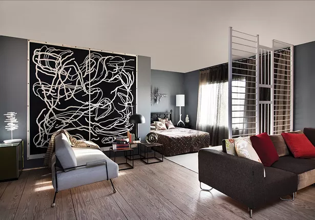 Gillette’s living and sleeping area is dominated by a two-panel print by Karl Klingbiel. The headboard is a 1960’s lacquered ebony bedroom set. - DEBORAH DEGRAFFENREID