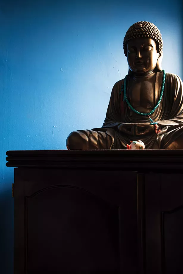 A gift from her mother, a Buddha statue graces a corner of her guest room. “I wake up every morning and make my gratitude list,” Bickman says. “I am so grateful to have the best patrons in the world.” - PHOTO BY DEBORAH DEGRAFFENREID